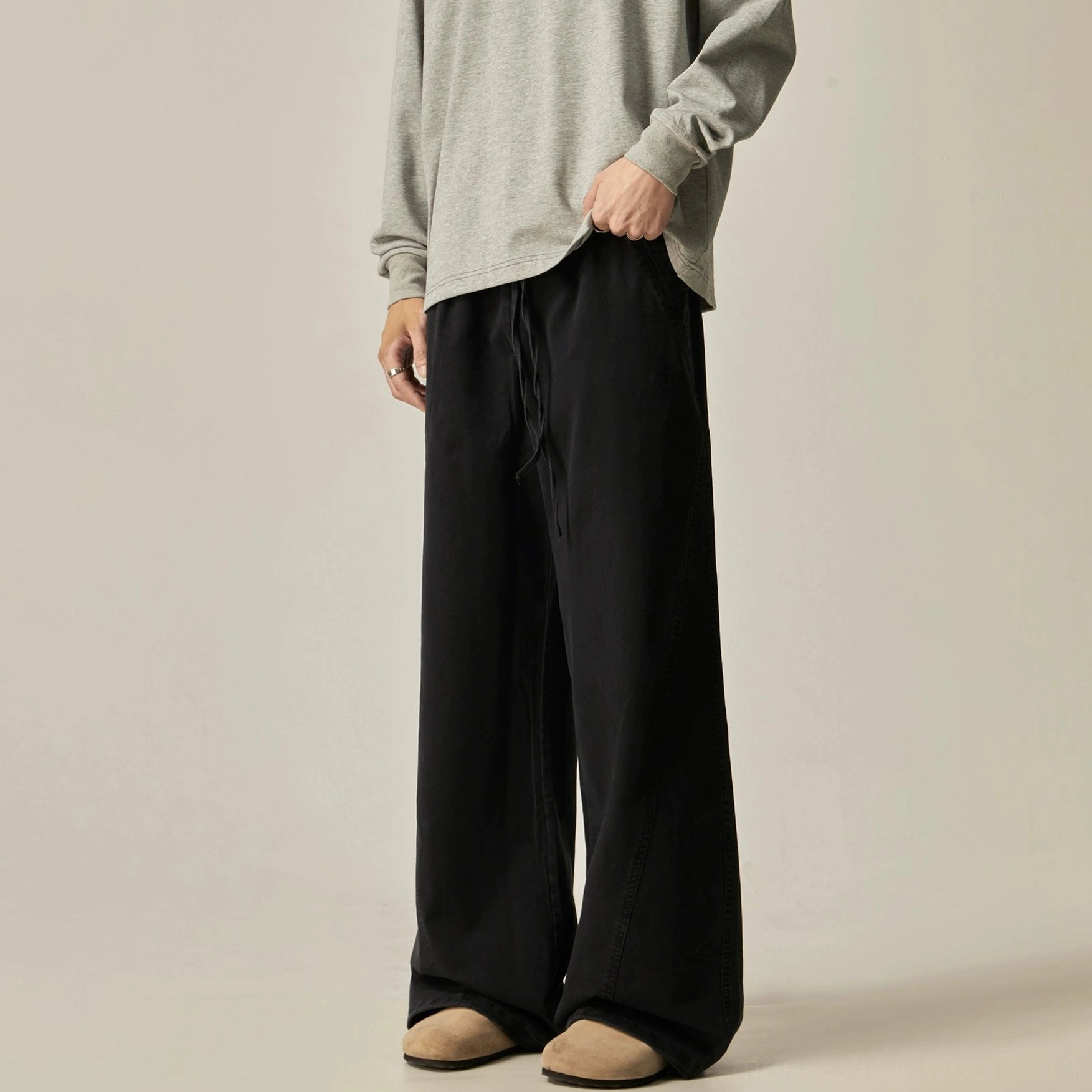 Black drawstring wide-leg pants floor-length hem solid black colorway relaxed silhouette versatile minimalist streetwear essential