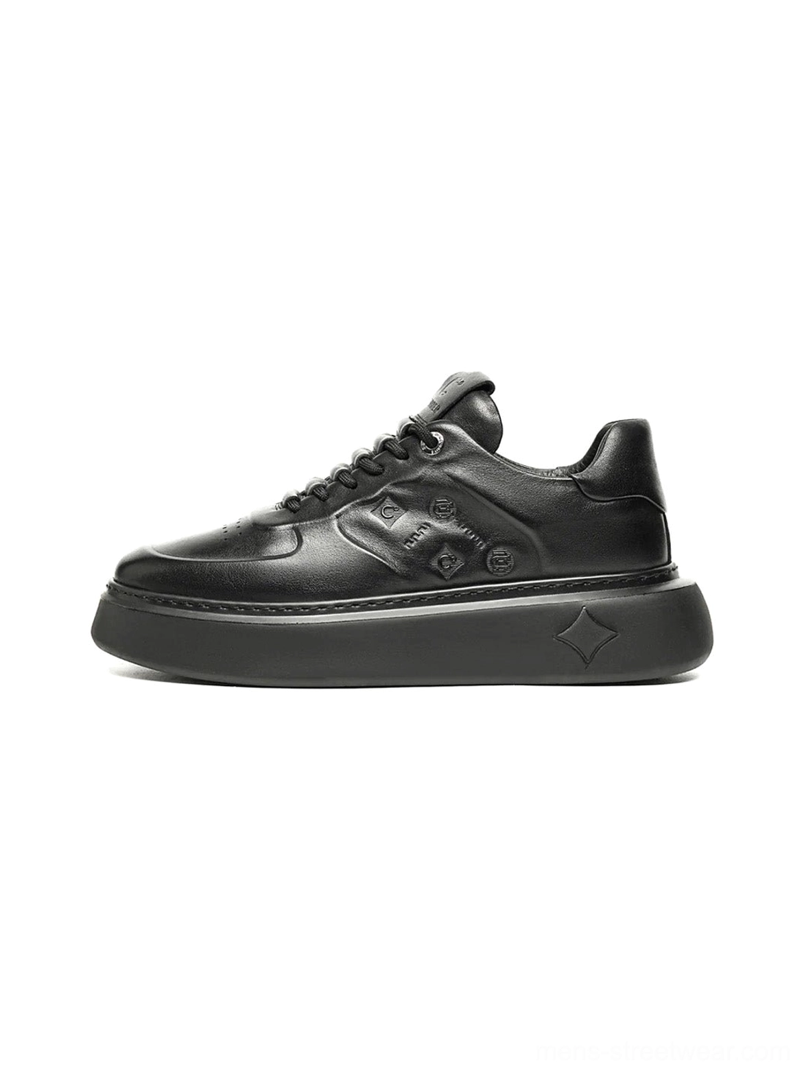 Black embossed platform sneakers shown from a low front-side angle with textured synthetic leather panels and chunky sculpted soles