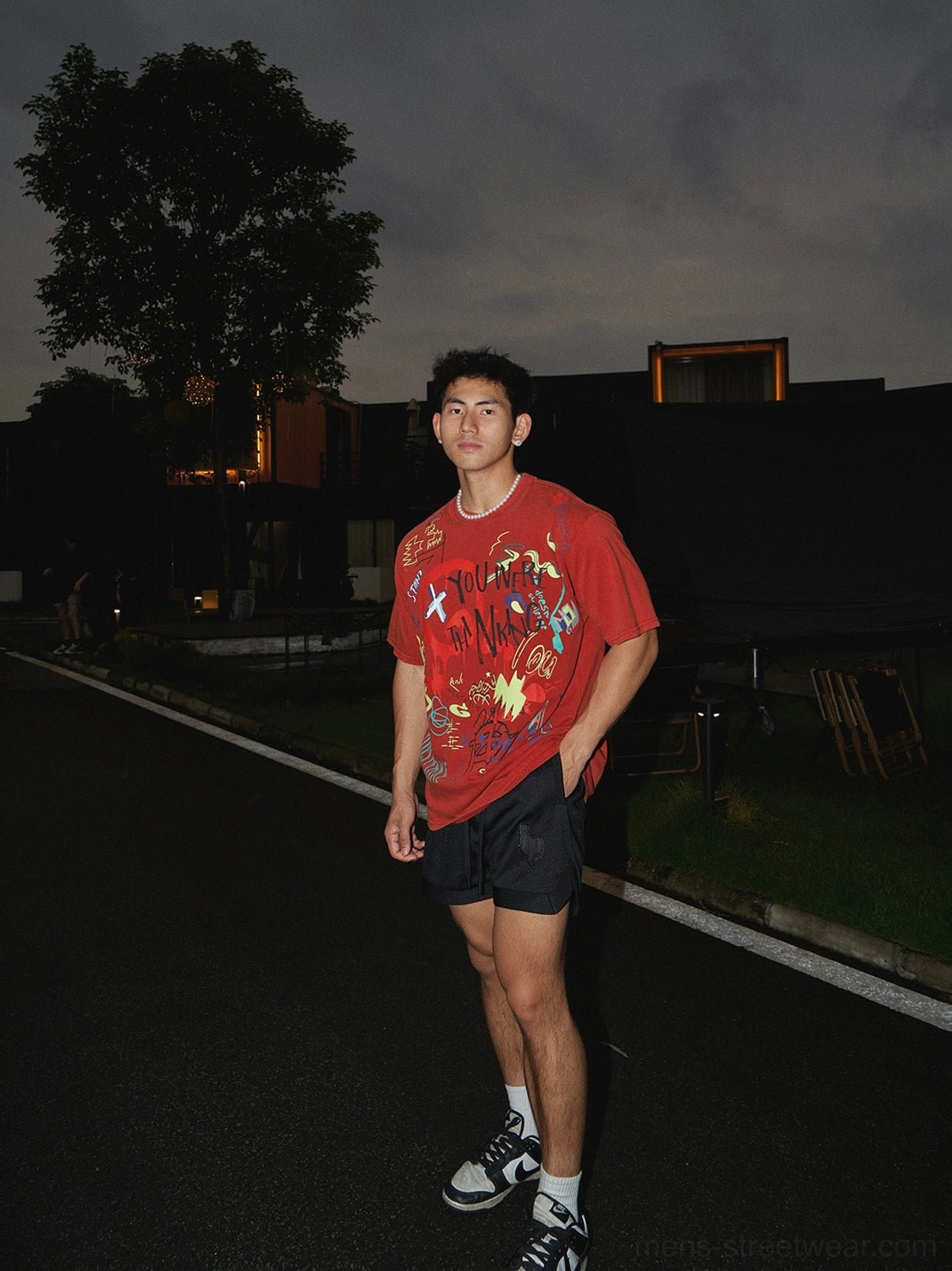 Black embroidered athletic shorts styled with an oversized vintage graphic red t-shirt for a relaxed Korean streetwear outfit
