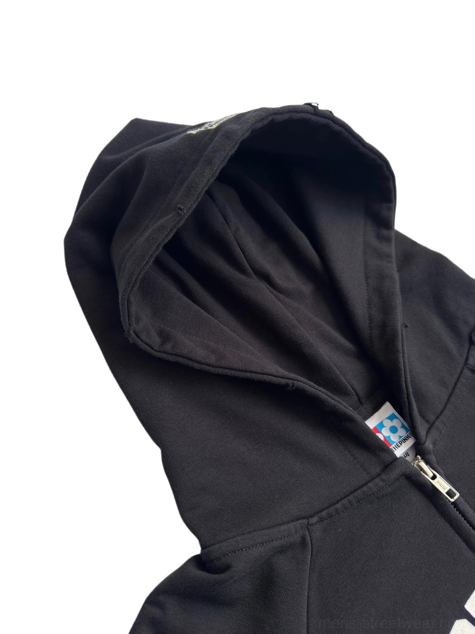 Close-up of black embroidered hoodie hood and metal zipper with softly lined drawstring hood and detailed streetwear construction