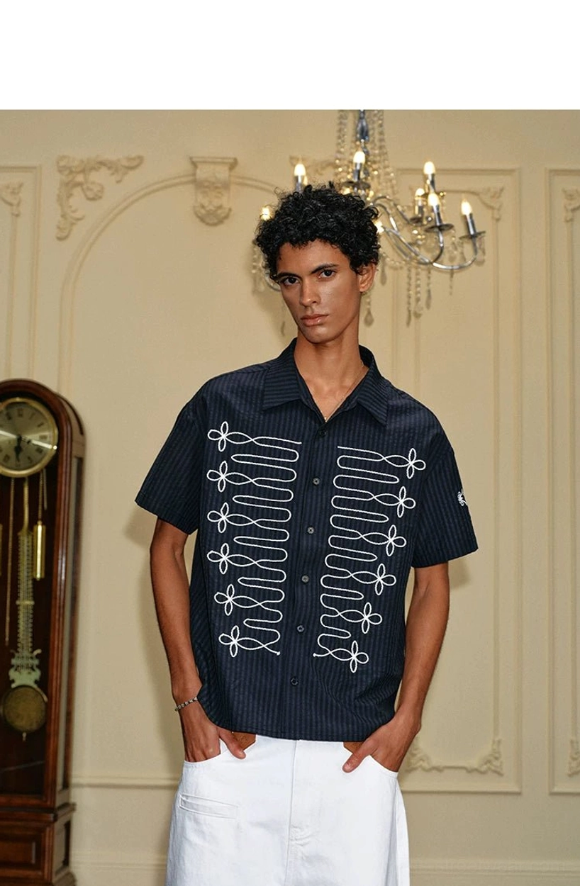 Full body outfit featuring black pinstripe embroidered loop shirt with white embroidery and white trousers