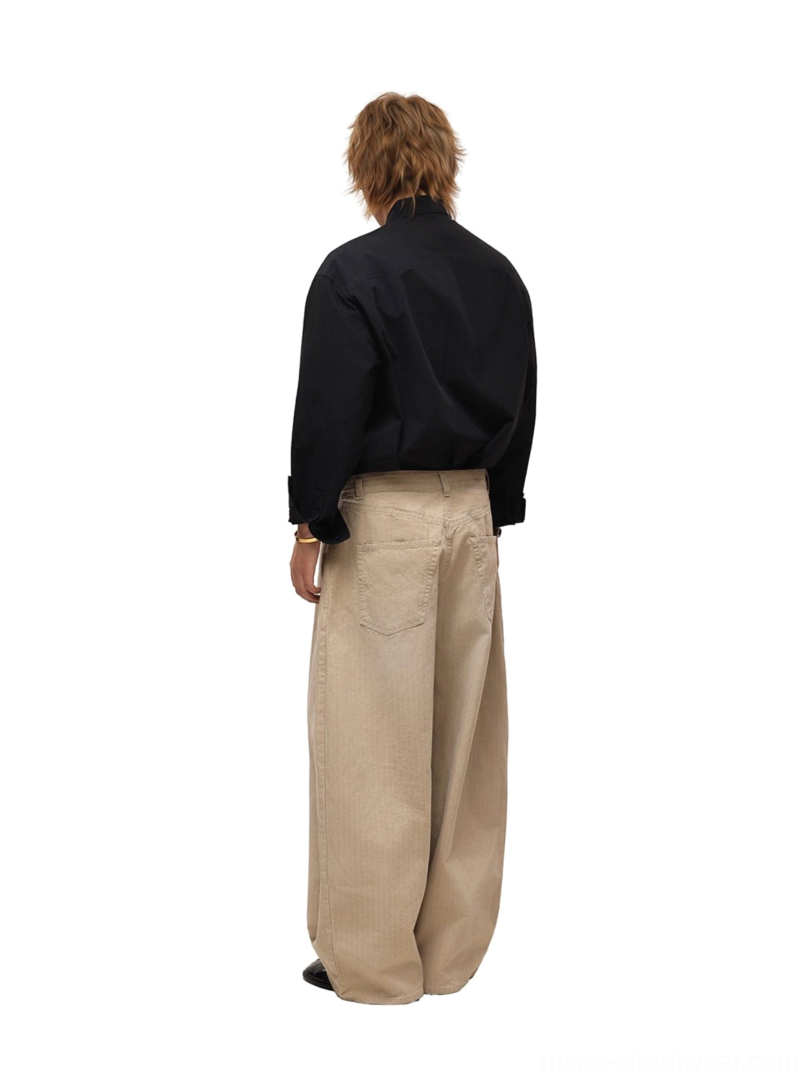 Back view of relaxed black cotton poplin streetwear shirt with curved hem and clean back yoke worn by male model