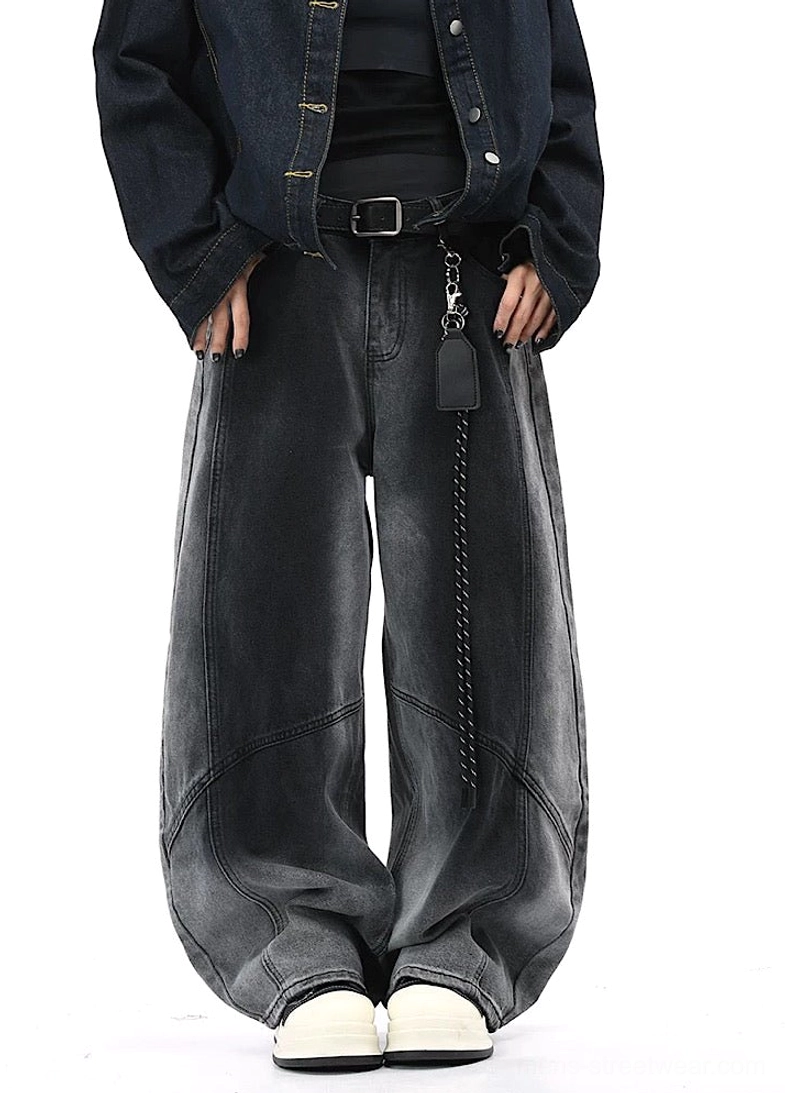 Front view of black faded wide-leg pants with relaxed loose fit and hands in pockets