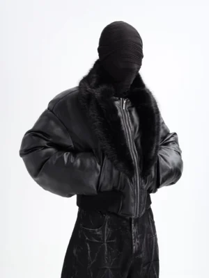 Three-quarter front view of a black faux fur collar cropped puffer jacket with padded bomber silhouette, ribbed hem, wide sleeves, and Seoul streetwear styling