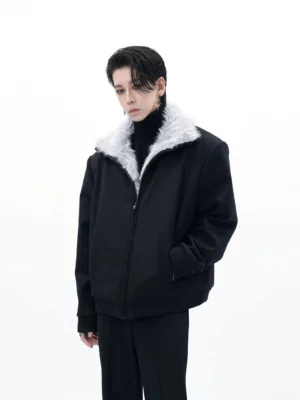 Men's black relaxed bomber jacket with light gray faux-fur collar styled with black turtleneck in white studio front view
