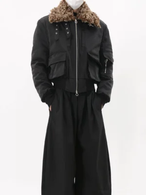Full front view of a men's black faux fur collar utility bomber jacket with brown textured collar, oversized cargo pockets, silver zipper, ribbed cuffs and cropped streetwear silhouette