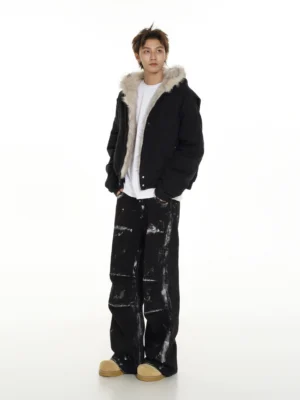 Black faux fur hooded bomber jacket shown from a rear three-quarter angle with cropped streetwear fit and soft fur lining