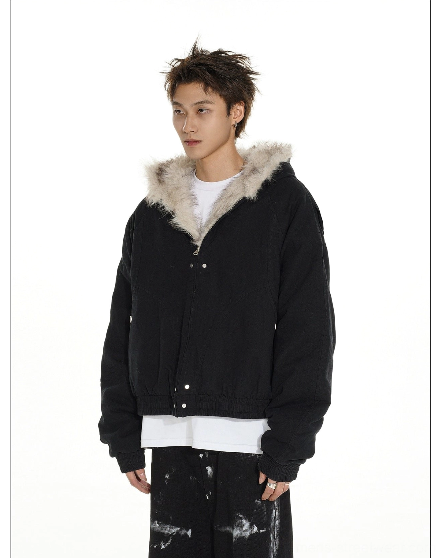 Black faux fur trimmed hooded bomber jacket shown from the front with snap closure and relaxed streetwear silhouette