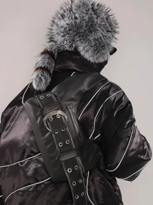 Black faux leather buckle belt hobo bag styled crossbody on the back with winter puffer jacket and Korean streetwear outfit