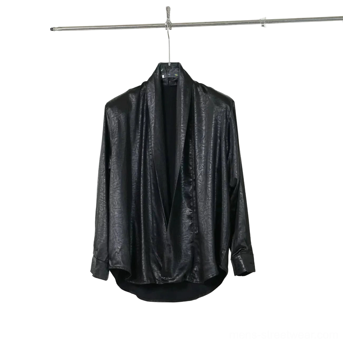 Black faux leather deep V draped shirt hanging on clothing rack showing curved hem loose long sleeves and crinkled glossy texture