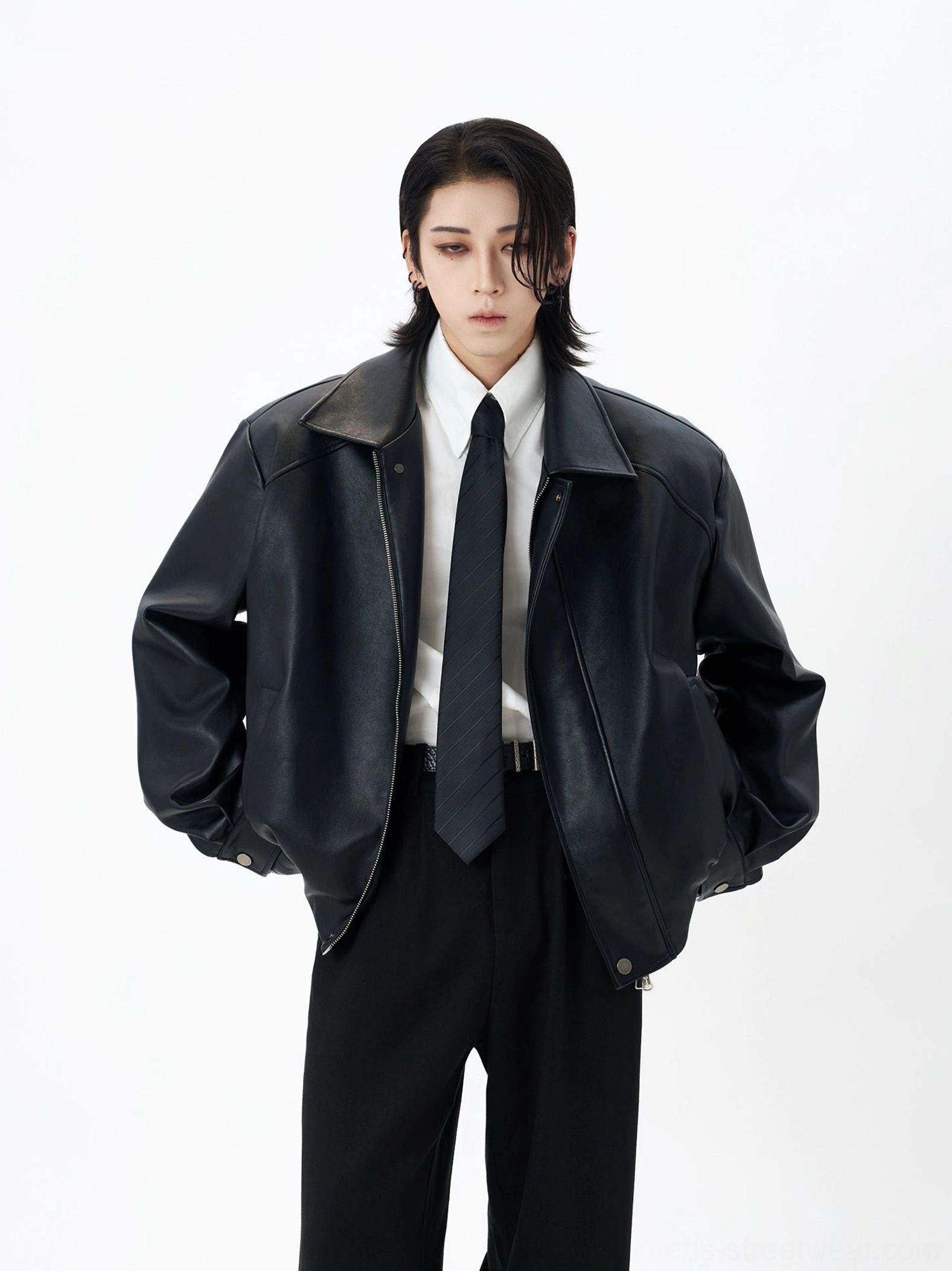 Black faux leather notched collar bomber jacket styled with white shirt and tie in studio
