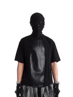 Back three-quarter view of a black faux leather panel oversized streetwear T-shirt with relaxed boxy fit and contrasting front panel
