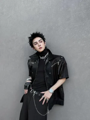 Black faux leather short sleeve moto overshirt three quarter side view with silver hardware and layered dark streetwear styling