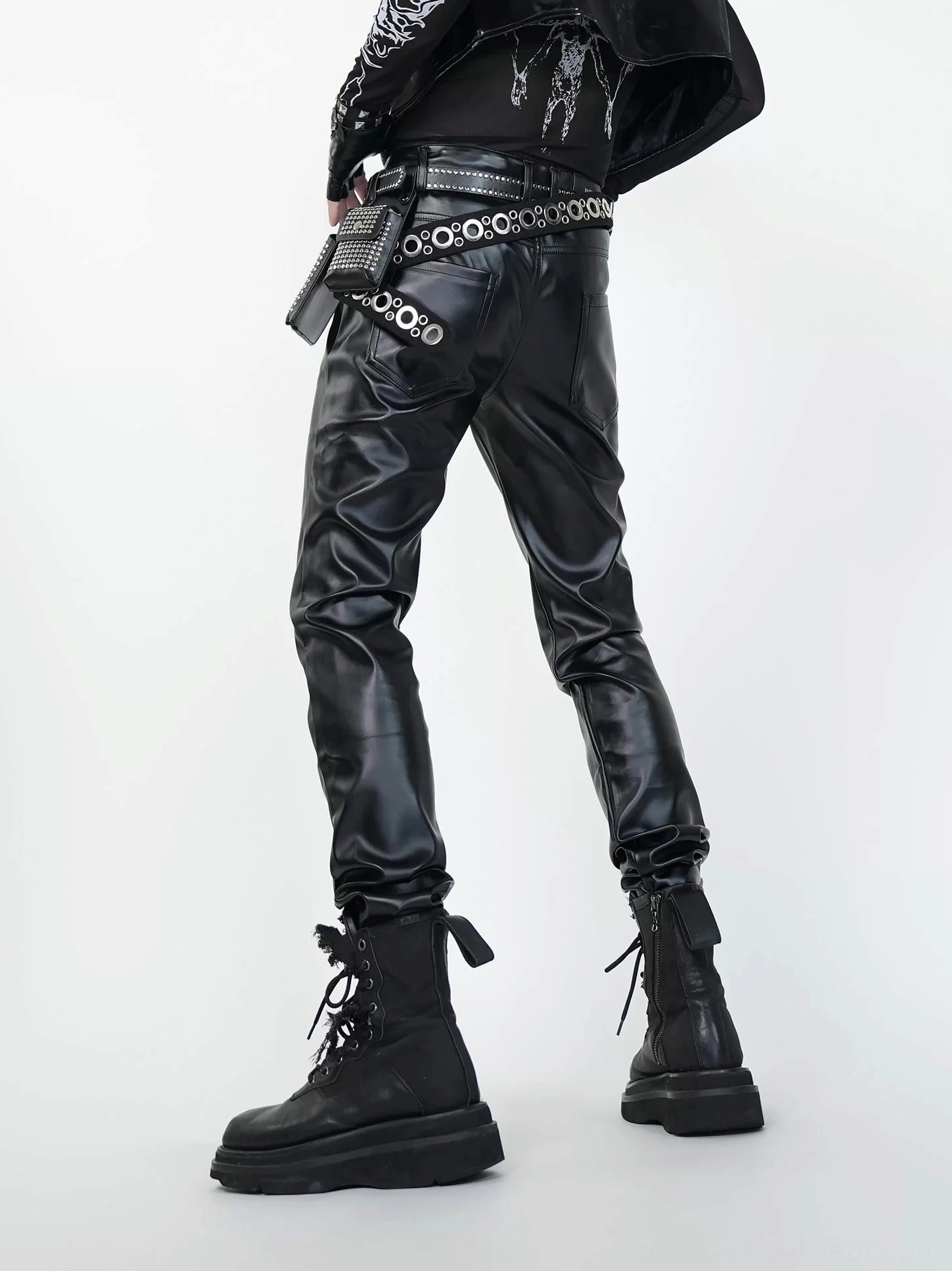 Rear view of black faux leather slim fit pants showing back pockets and tapered ankle cut for combat boots