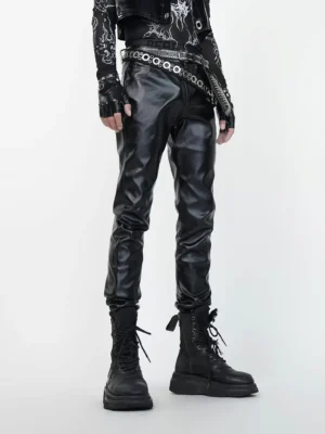 Front view of black slim faux leather combat pants styled with studded belts in a goth biker streetwear outfit