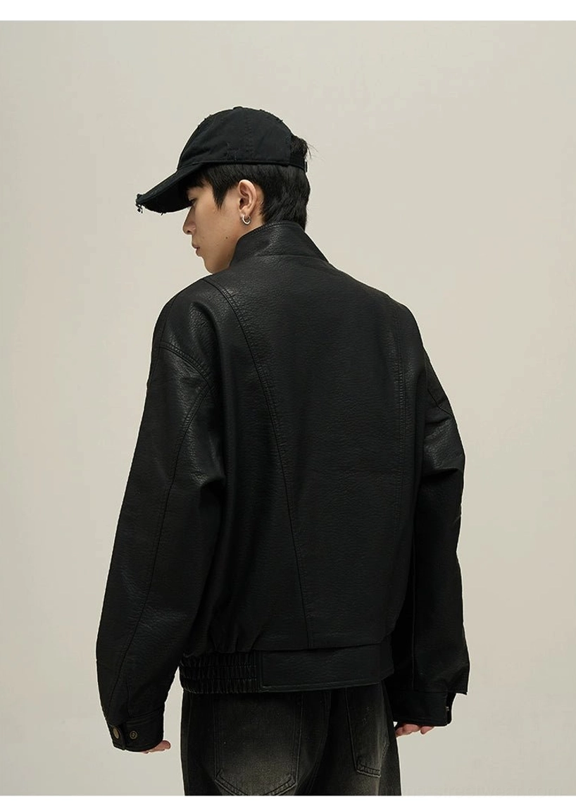Black faux leather stand collar bomber jacket back three-quarter view showing structured back seams and ribbed hem