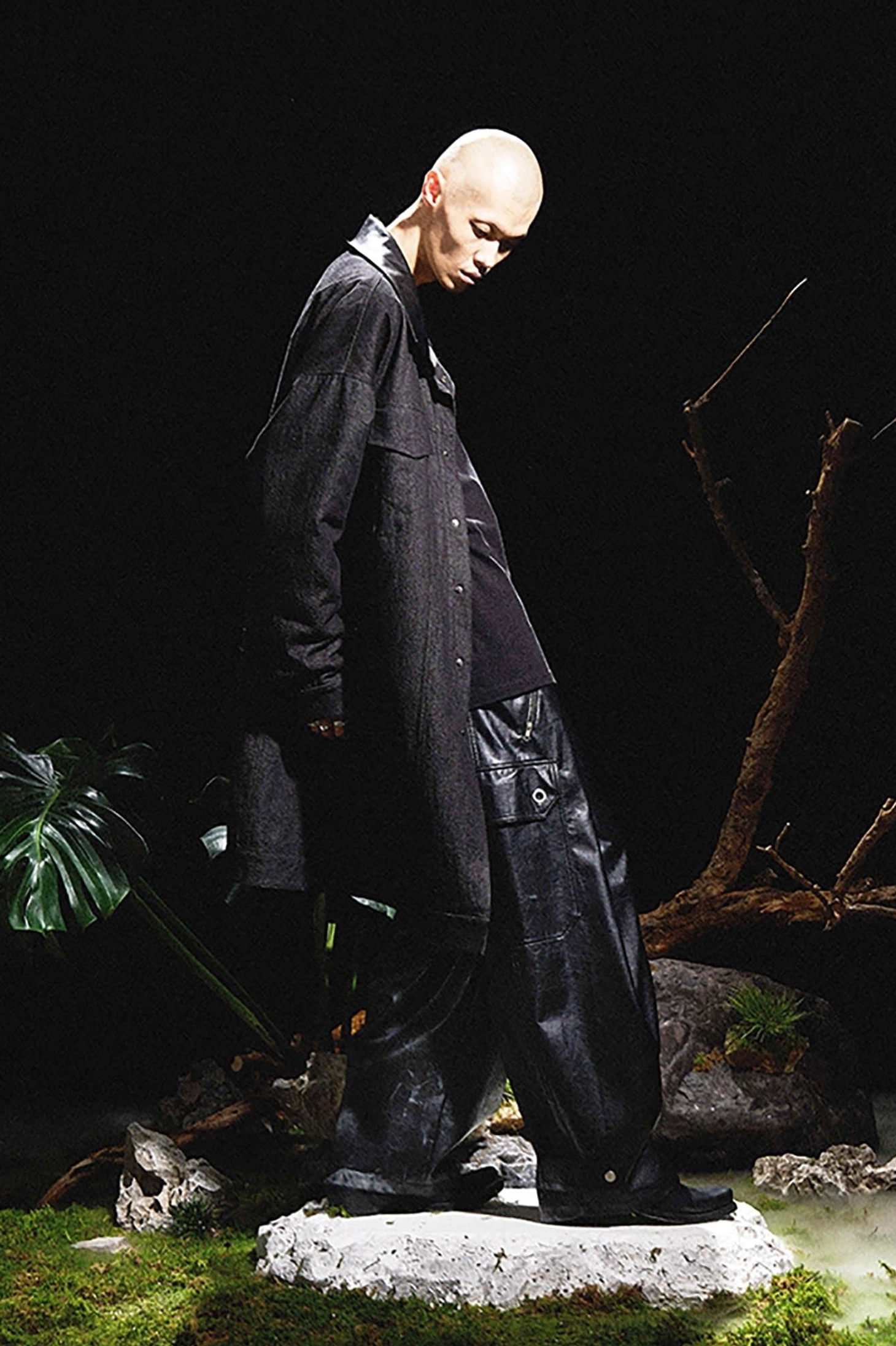 Black faux leather wide-leg cargo pants styled with an oversized black coat in a dark gothic outfit