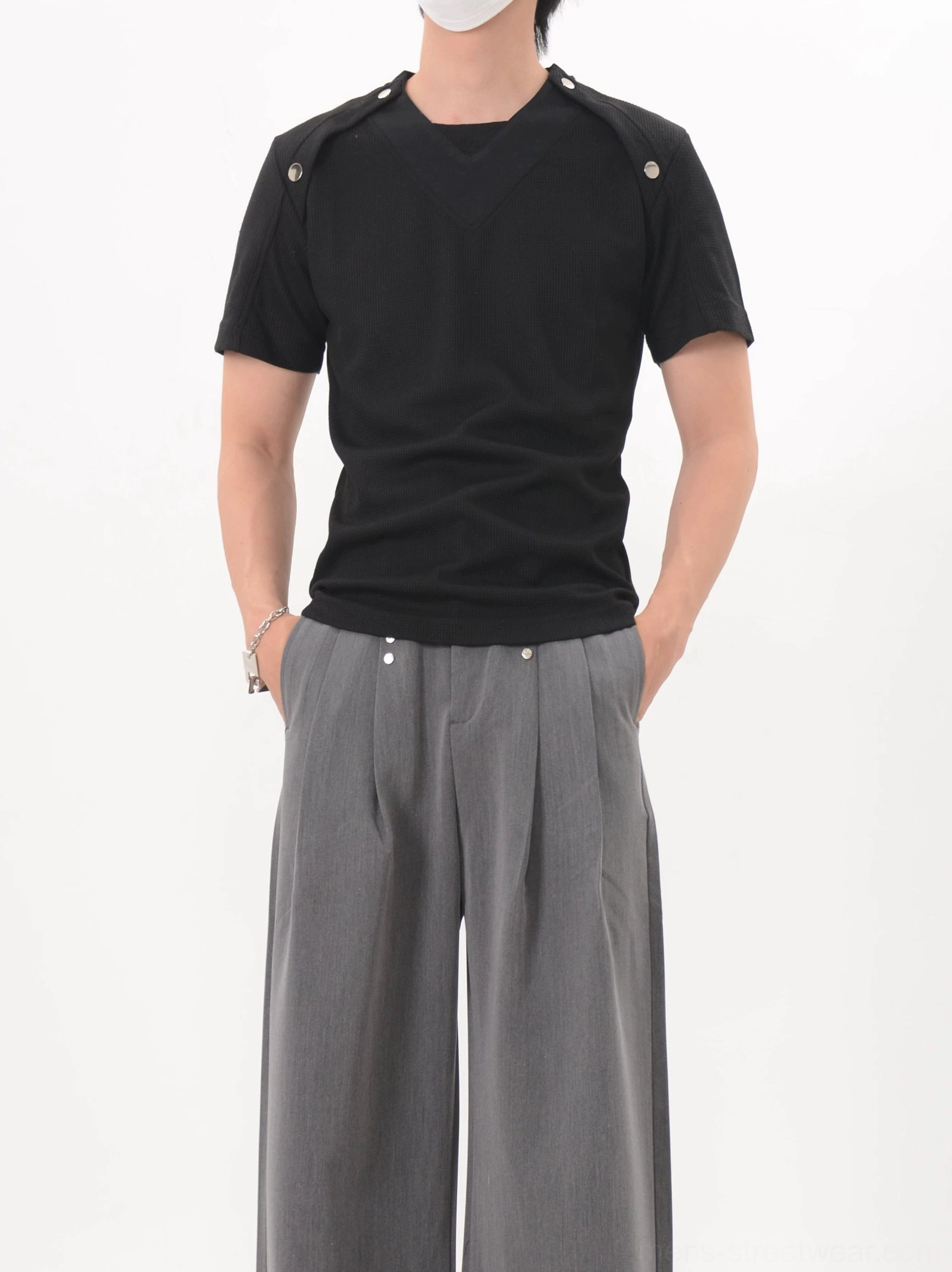 Black fitted shoulder snap knit tee shown from the right front with V-panel construction and contemporary East Asian streetwear styling