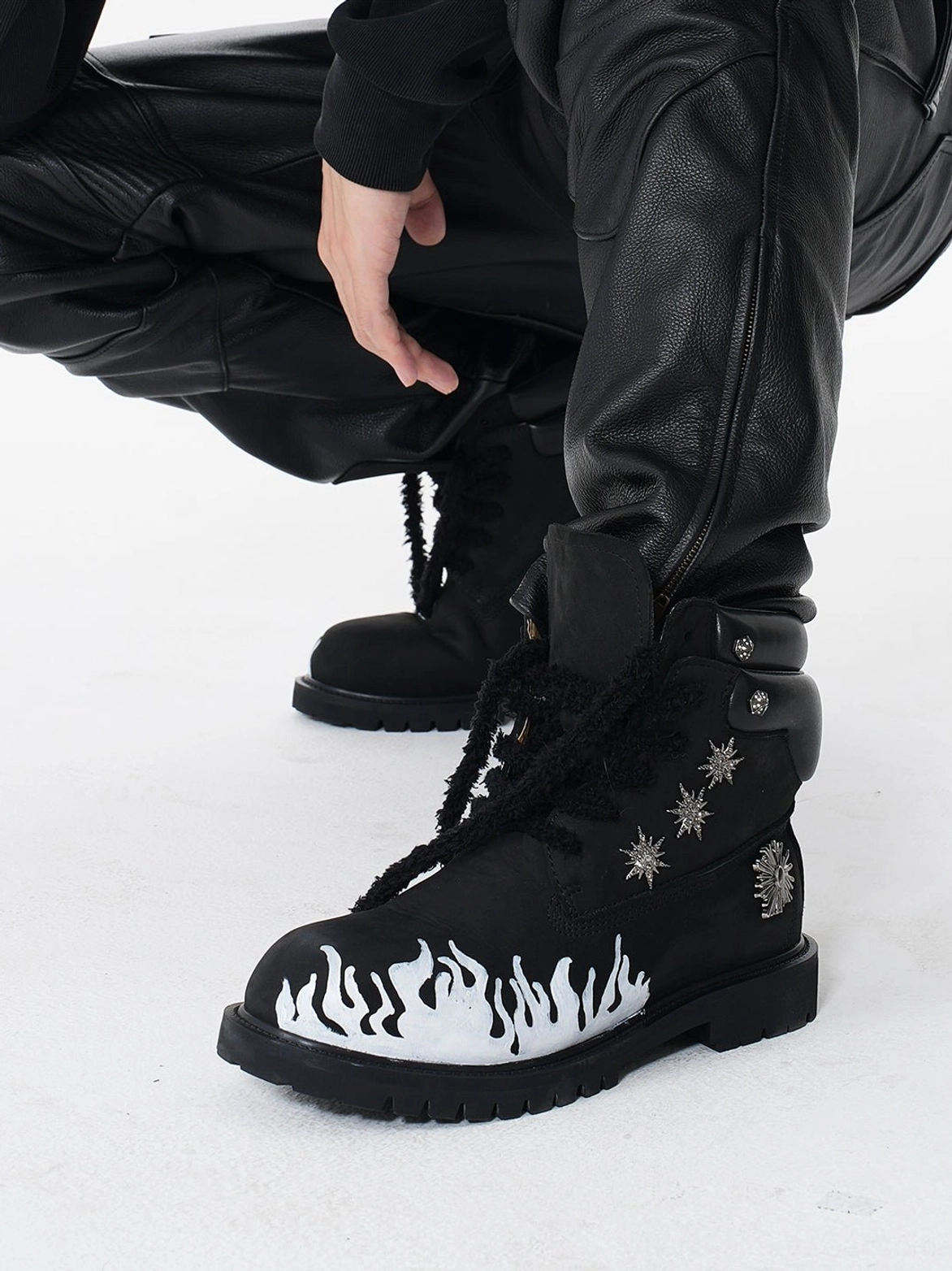 Black flame appliqué genuine leather combat boots with contrast white flames and chunky lug sole