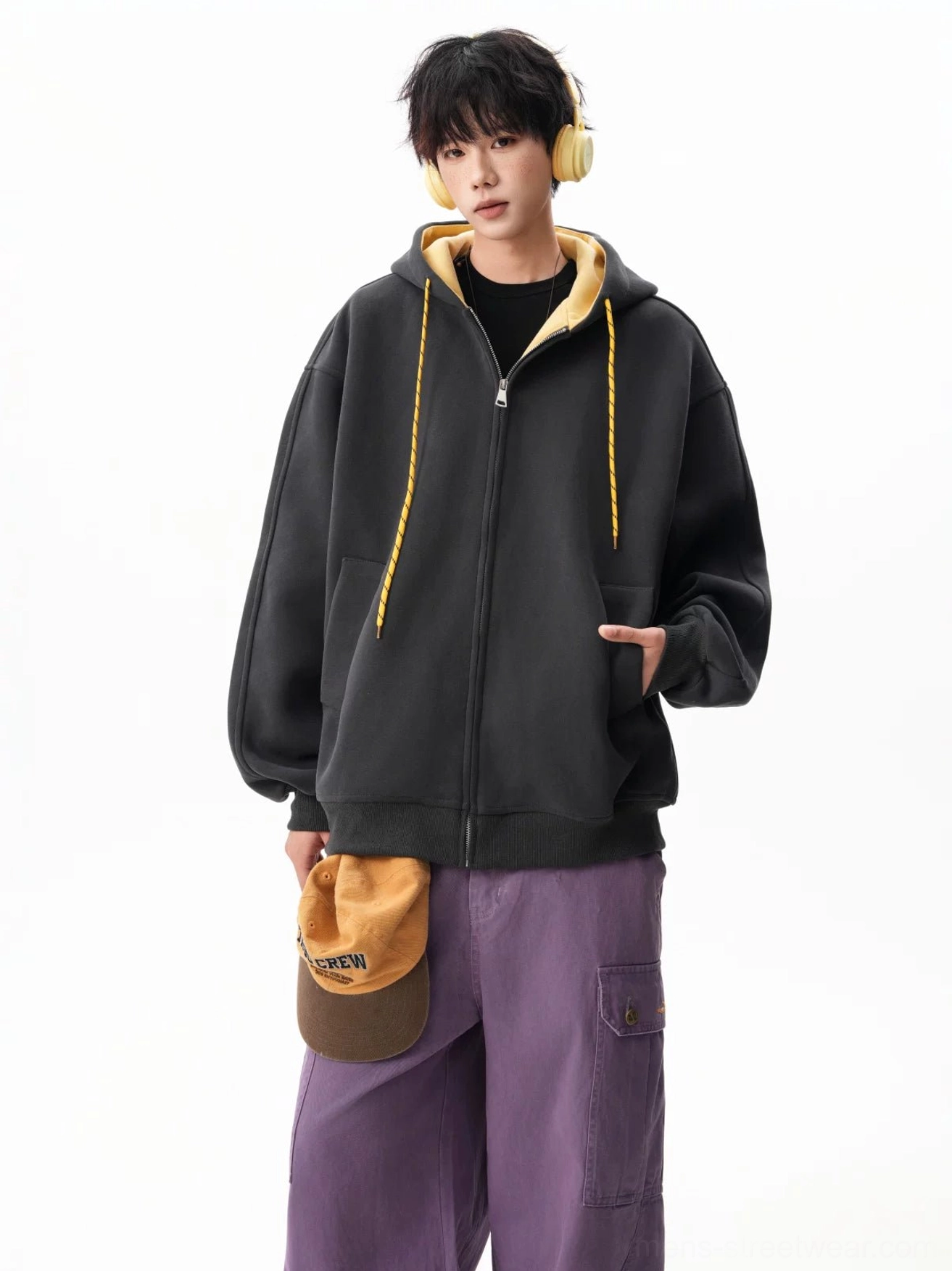 Black fleece contrast zip-up hoodie with yellow hood lining and drawstrings styled in a bold streetwear outfit