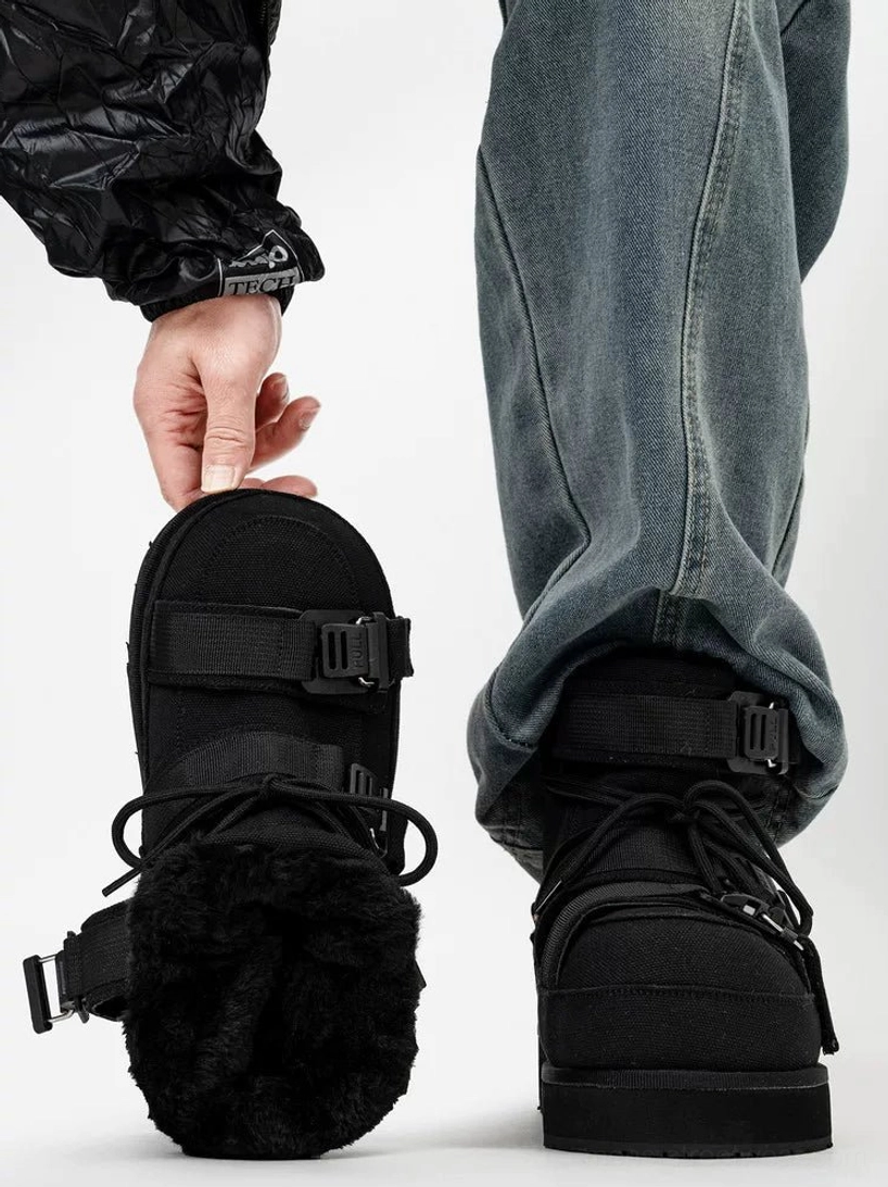 Black fleece-lined quilted platform moon boot held beside worn boot, showing soft inner lining and utility buckle straps