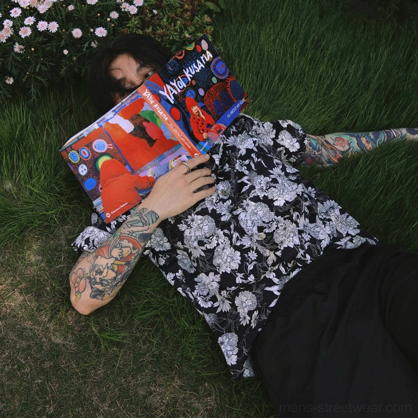 Black floral print vacation shirt styled with black wide leg pants in an outdoor streetwear look