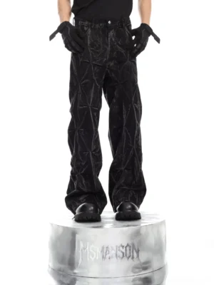Front view of black fracture crinkle wide-leg denim pants with washed finish, geometric textured surface, and relaxed streetwear silhouette