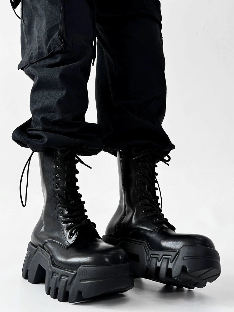 Black futuristic lace up platform combat boots with smooth glossy upper and monochrome black hardware