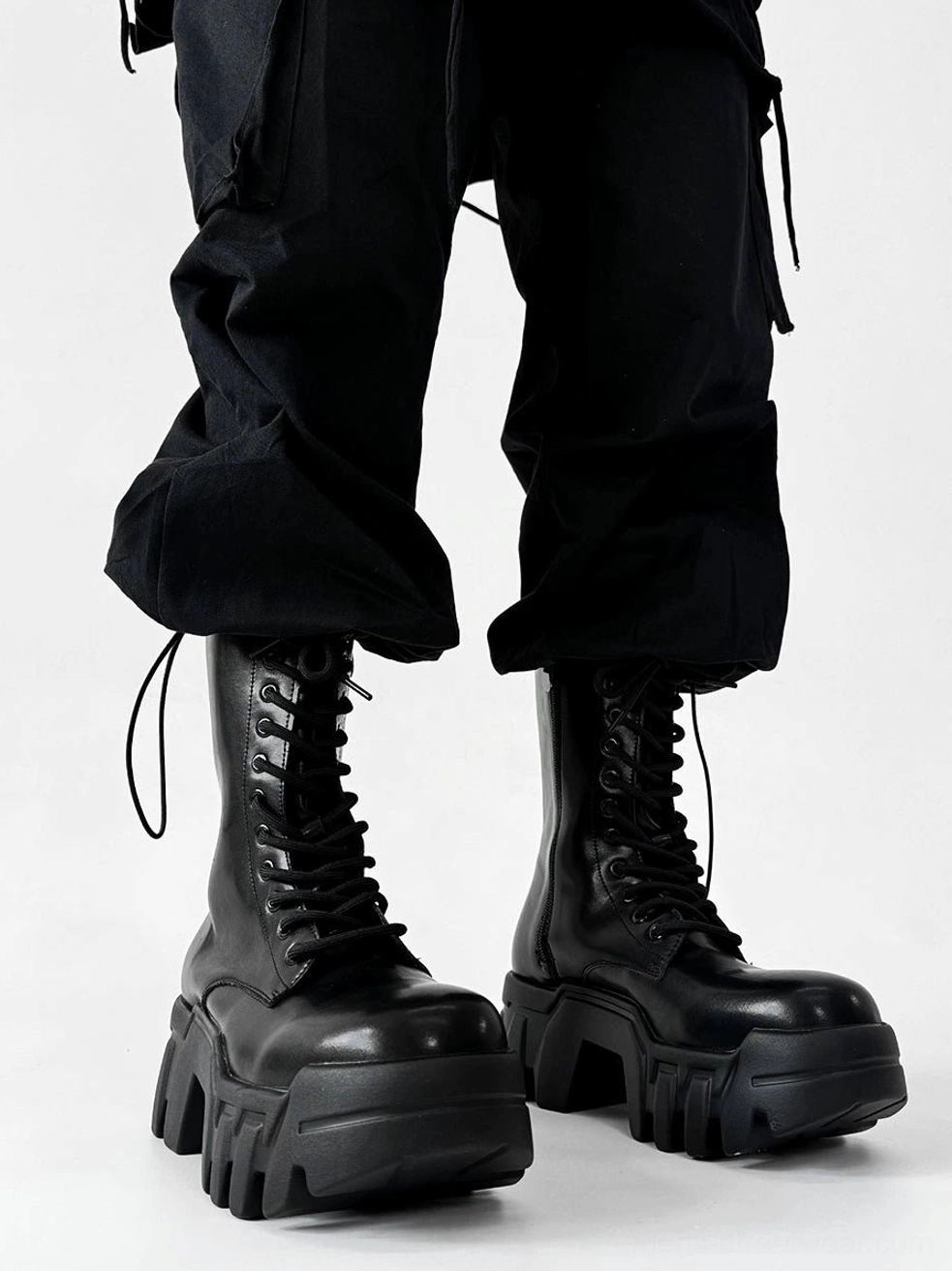 Black futuristic zip platform combat boots with glossy microfiber leather upper and heavy lug sole