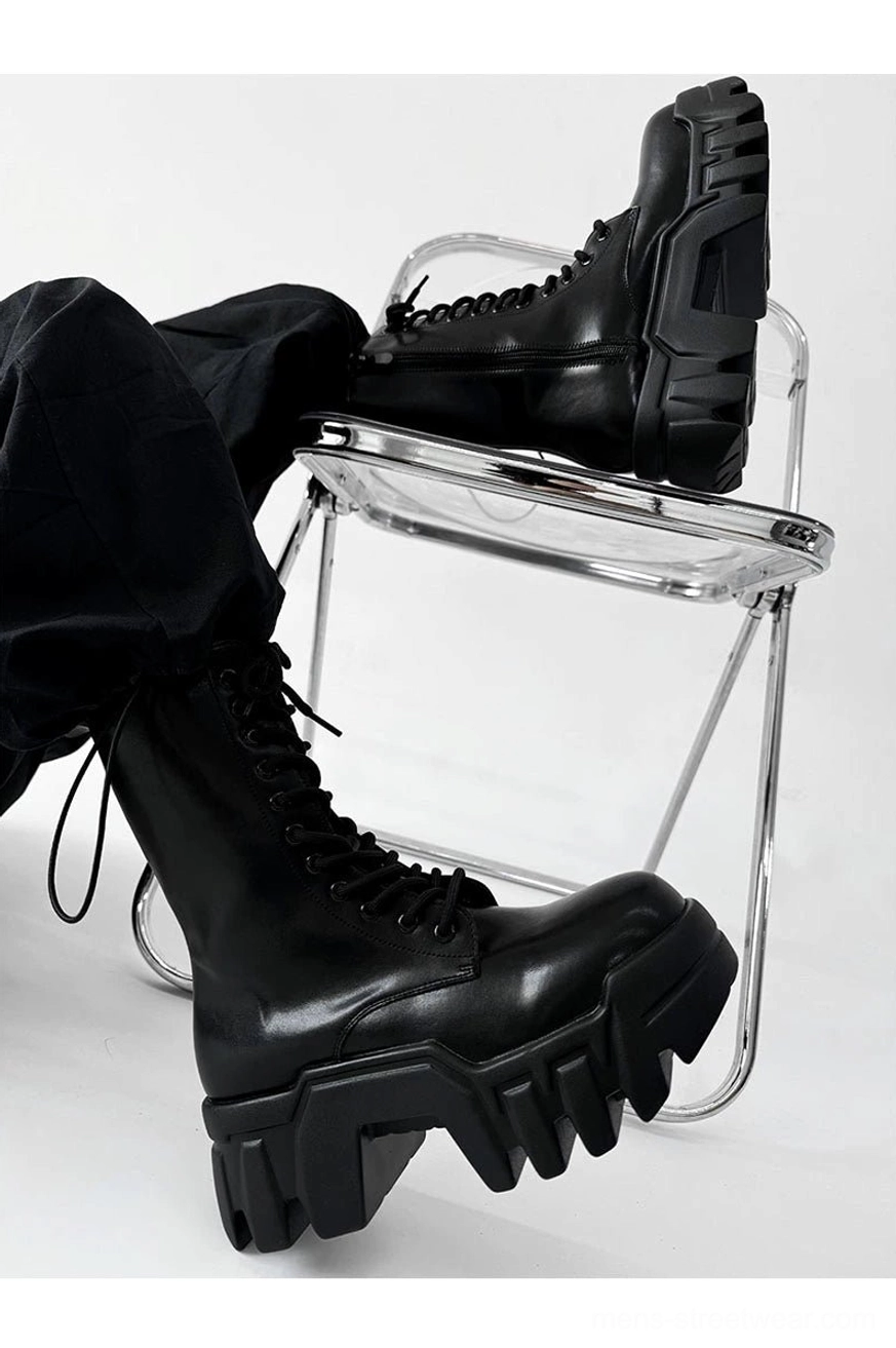 Close low angle view of black futuristic zip platform combat boots on metal folding chair