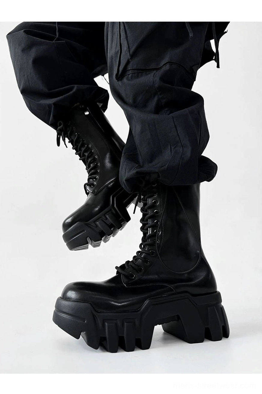 Rear side view of black mid calf futuristic platform combat boots with geometric chunky soles