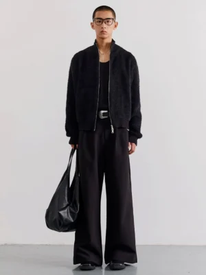 Black fuzzy zip-up fleece cardigan worn in a full-body front view with stand collar and cropped relaxed streetwear fit