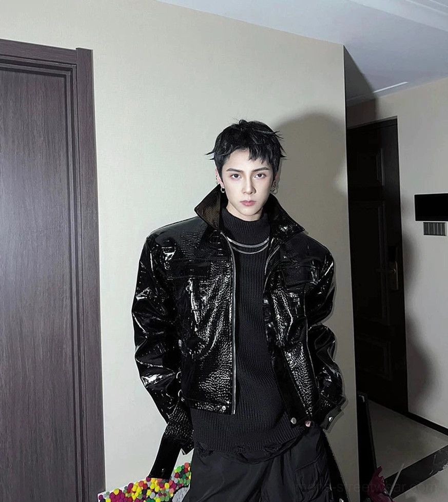 Full front view of black glossy crocodile embossed faux leather moto jacket with spread collar and chest pockets