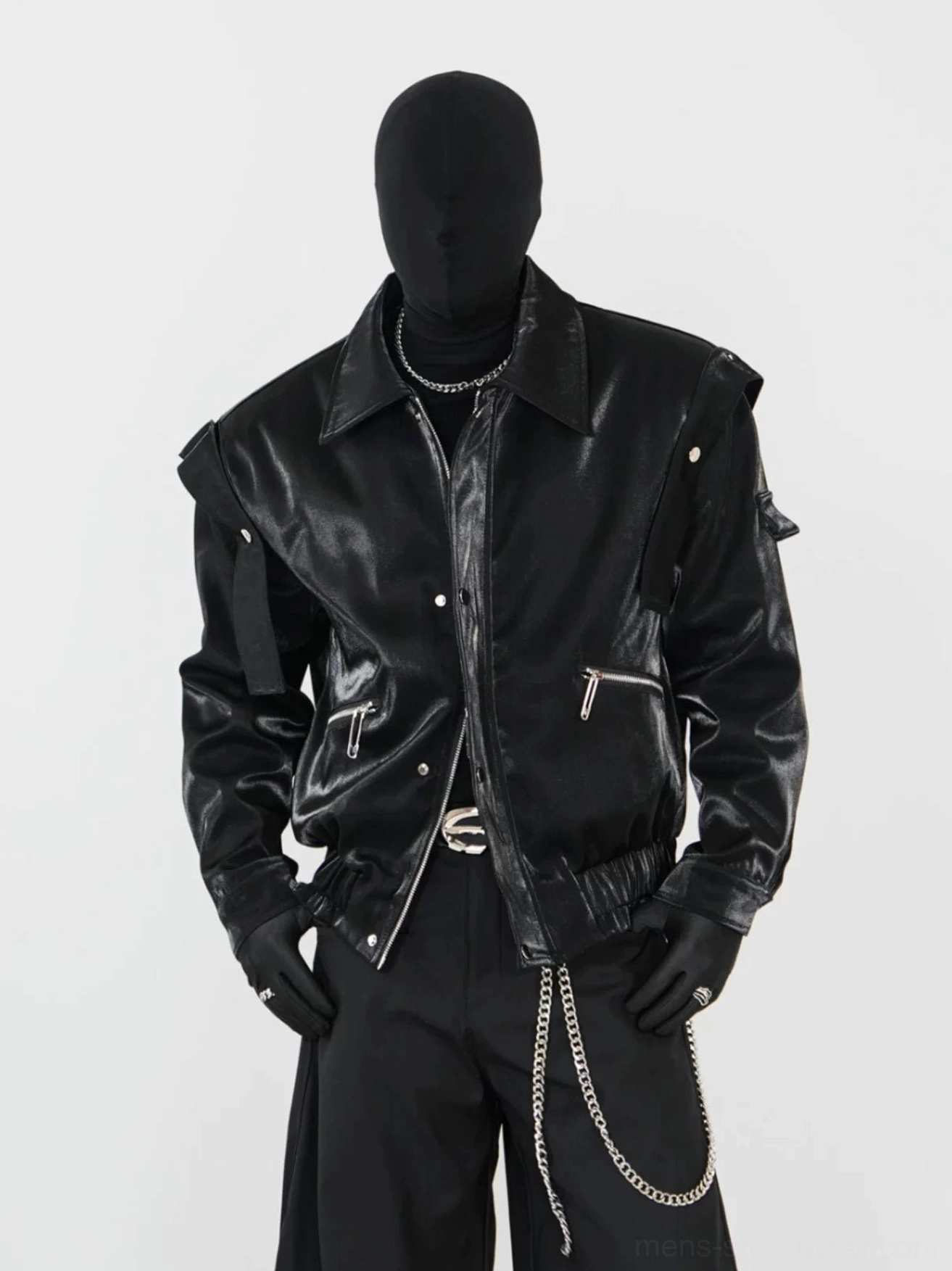Black glossy faux leather modular biker jacket with notched lapel, zip pockets, snap fasteners, and futuristic streetwear styling on a mannequin
