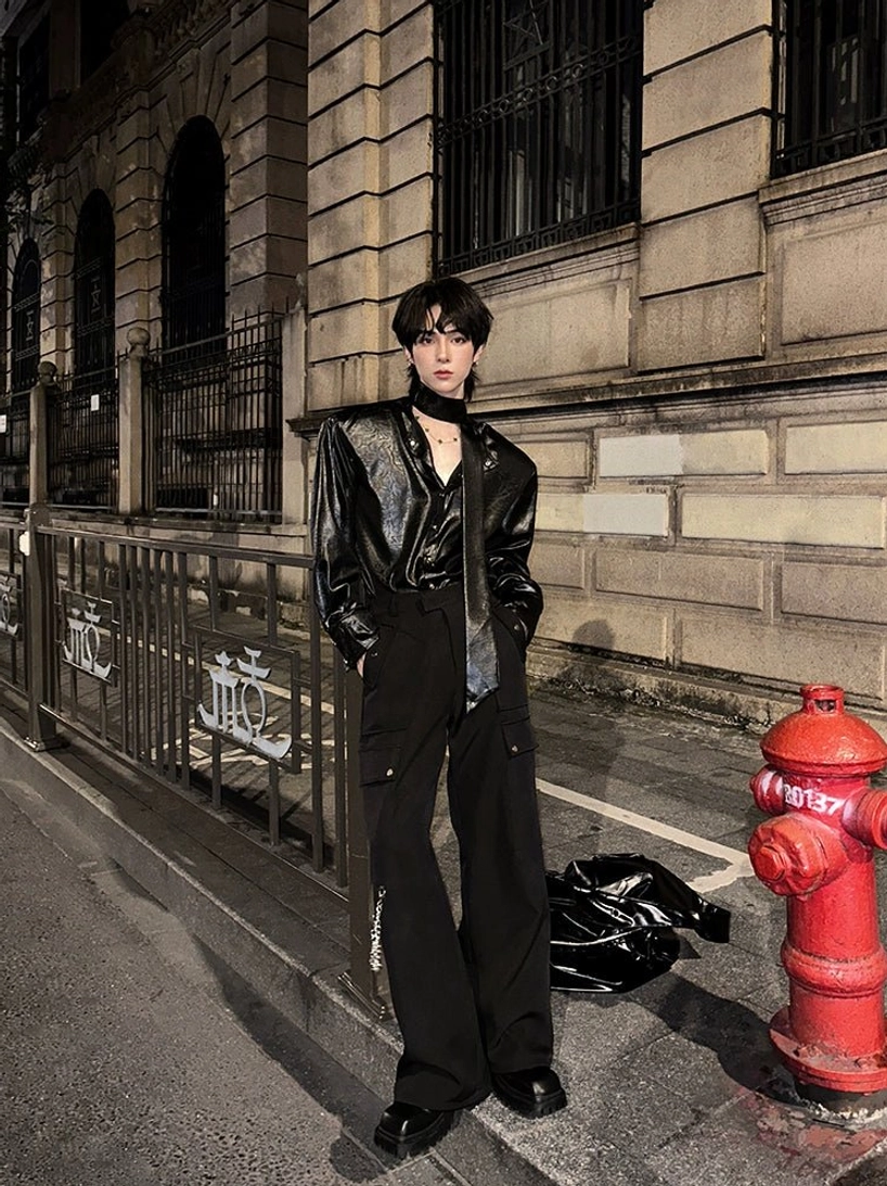 Black glossy tie-neck streetwear shirt styled with wide-leg trousers for an avant-garde night outfit