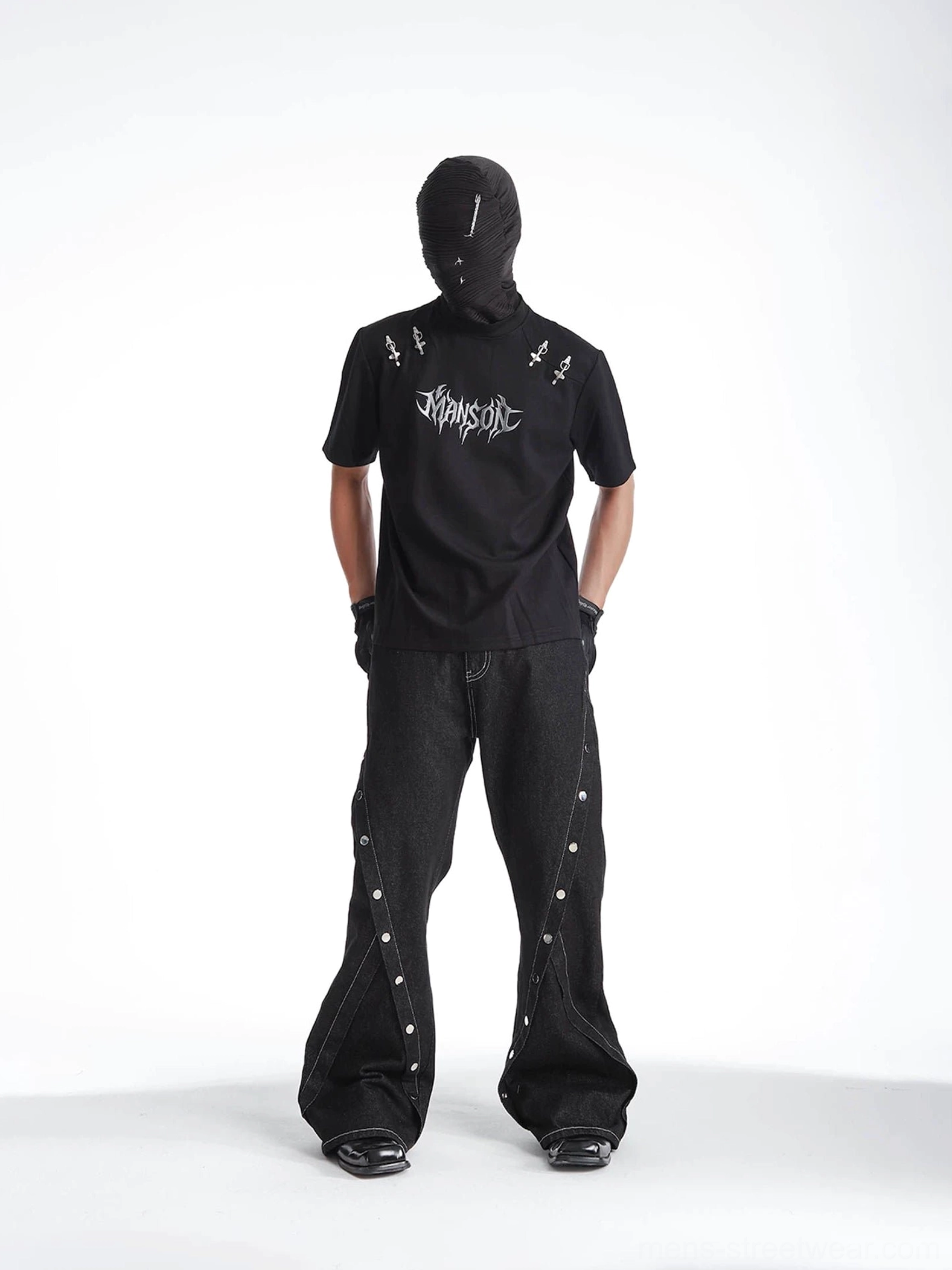Flat lay front and back display of a black gothic graphic T-shirt with silver chest print, dagger shoulder hardware, and plain back