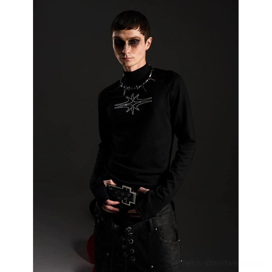Front styling of black gothic mockneck long sleeve top with abstract star graphic and dark alternative streetwear accessories