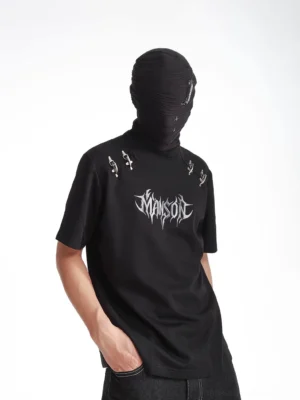 Three-quarter view of a black gothic streetwear T-shirt featuring a silver graphic print and metallic dagger shoulder embellishments