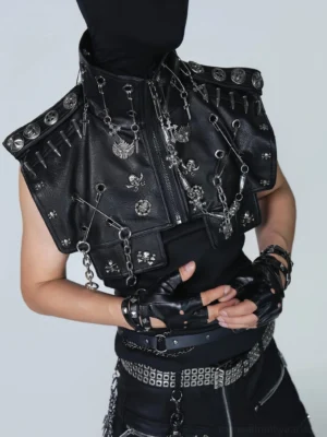 Close-up of black PU leather gothic punk harness vest with high stand collar zipper safety pins skull charms chains and silver metal hardware