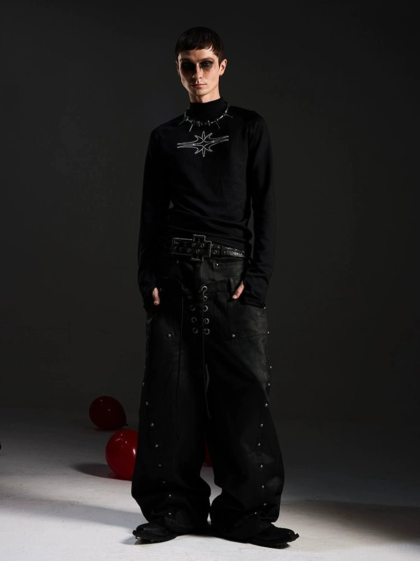 Full body styling of black gothic star mockneck top with punk double belt and studded wide leg streetwear jeans
