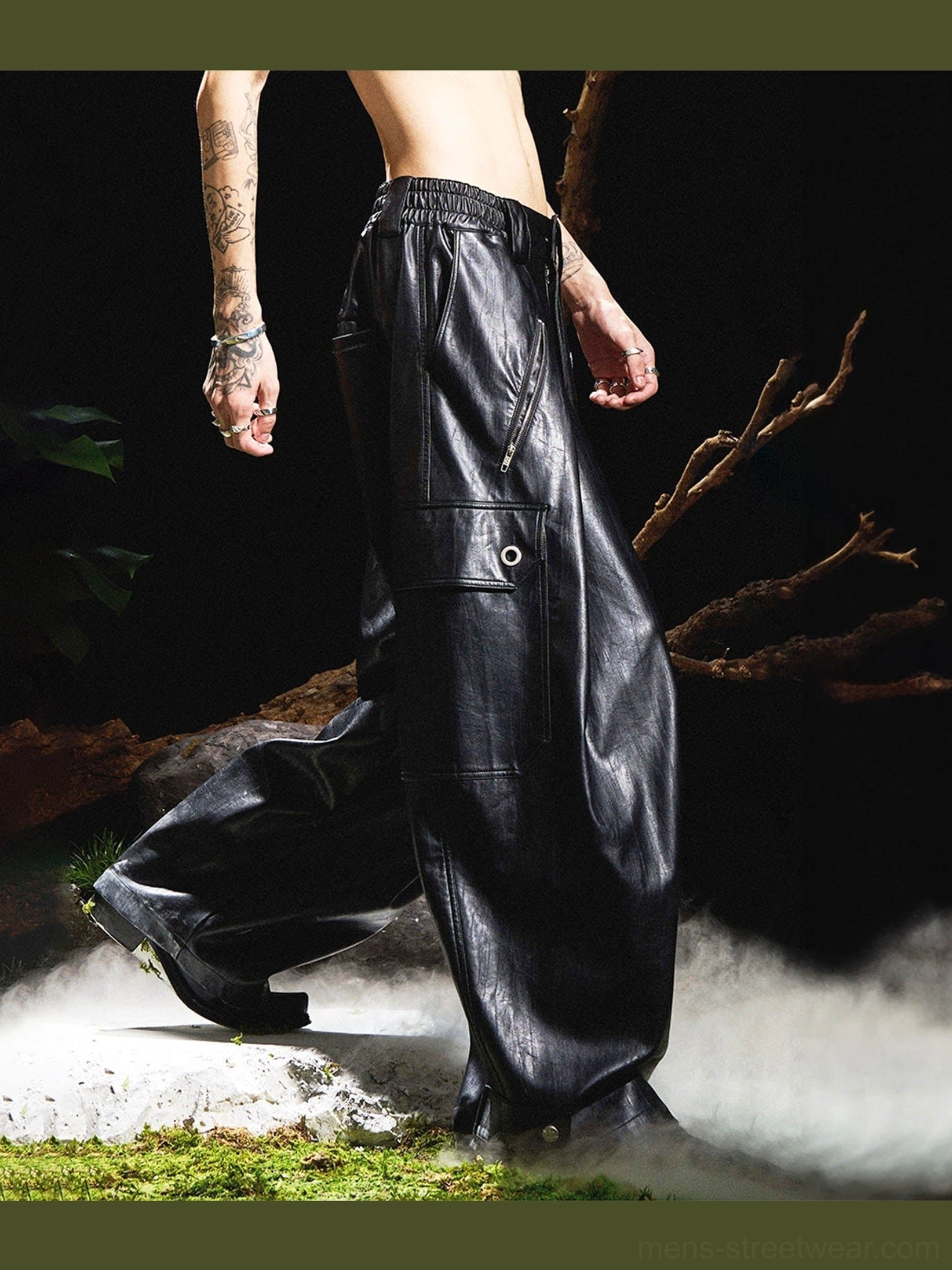 Rear low-angle view of black gothic wide-leg faux leather cargo pants with oversized legs, utility pocket and stacked hem