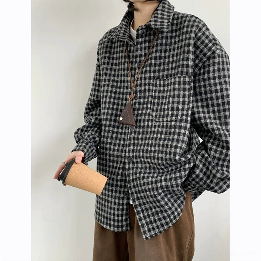 Front upper-body view of black and gray plaid flannel shirt with oversized silhouette pointed collar chest pocket and brushed fabric
