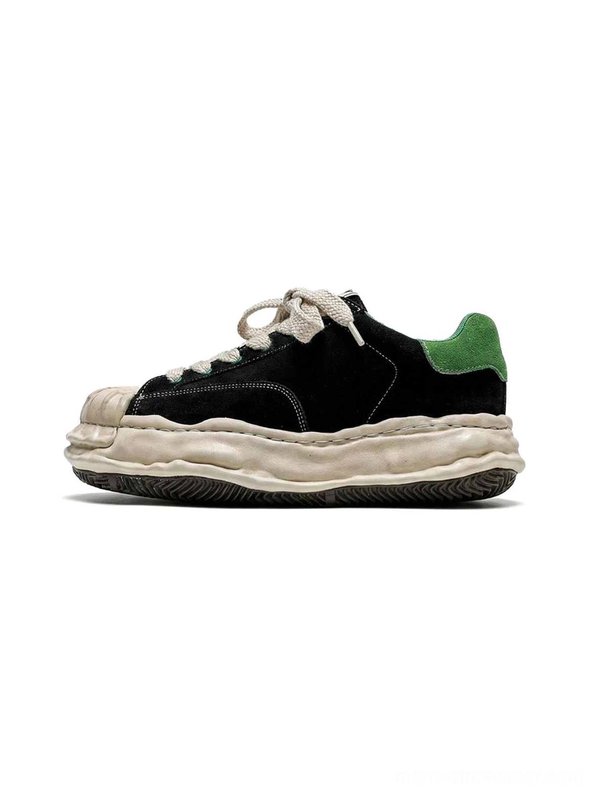 Black and green shell-toe platform sneakers with textured suede upper, cream chunky sole, and green heel tab shown in a three-quarter product view