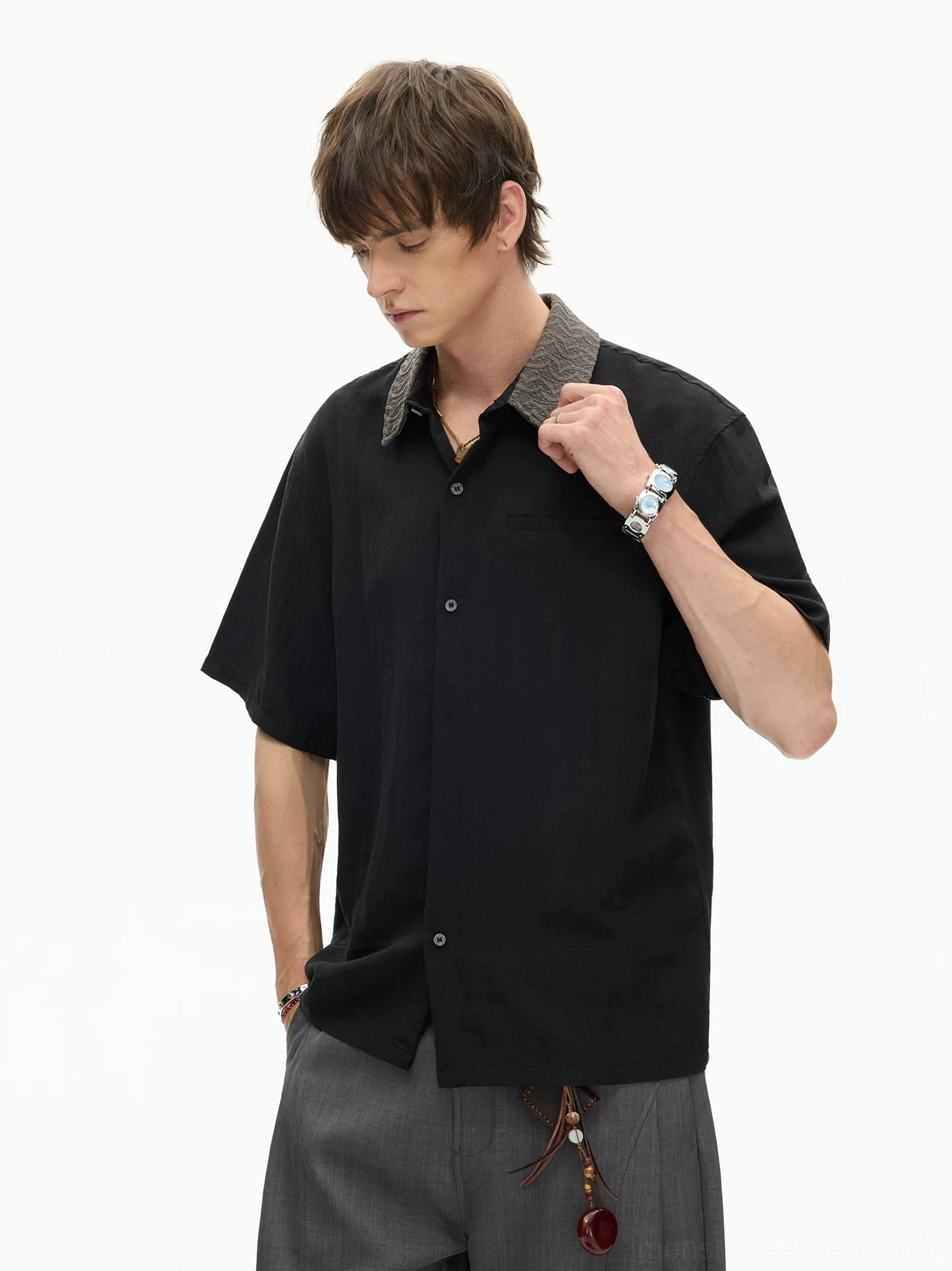 Black short sleeve streetwear shirt with grey textured contrast collar and chest pocket styled with loose trousers