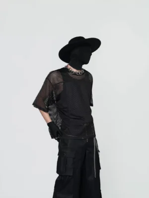 Front three-quarter view of a black grid mesh crew neck tee styled with cargo pants and silver chain accessories