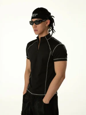 Side three-quarter view of fitted black half-zip tee with white contrast seams and short sleeves
