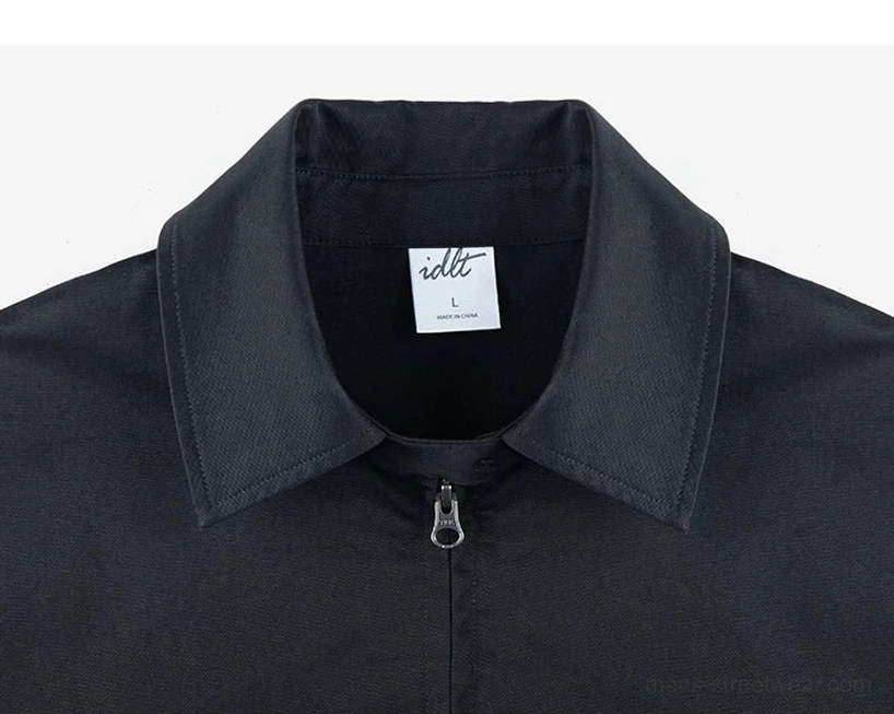 Front close-up of the black Harrington jacket collar and minimalist metal zipper placket with a crisp Korean streetwear silhouette