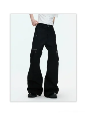 Side view of black high waist wide leg streetwear pants with exposed metal zipper pocket and floor length silhouette