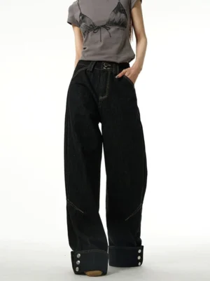 Front full-body view of black high-waisted wide-leg jeans with rolled cuffs, classic belt loops, visible leg seams, and relaxed Seoul streetwear styling