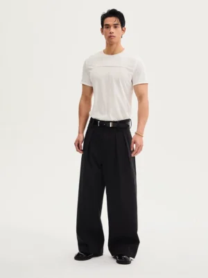 Front view of black high-waisted wide-leg streetwear trousers with front pleats, white T-shirt, black belt, and leather dress shoes